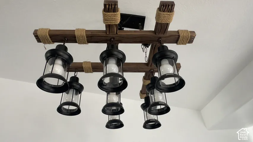 Decorative lighting fixture featuring wood-finish beams, rope accents, and multiple black lantern-style lights