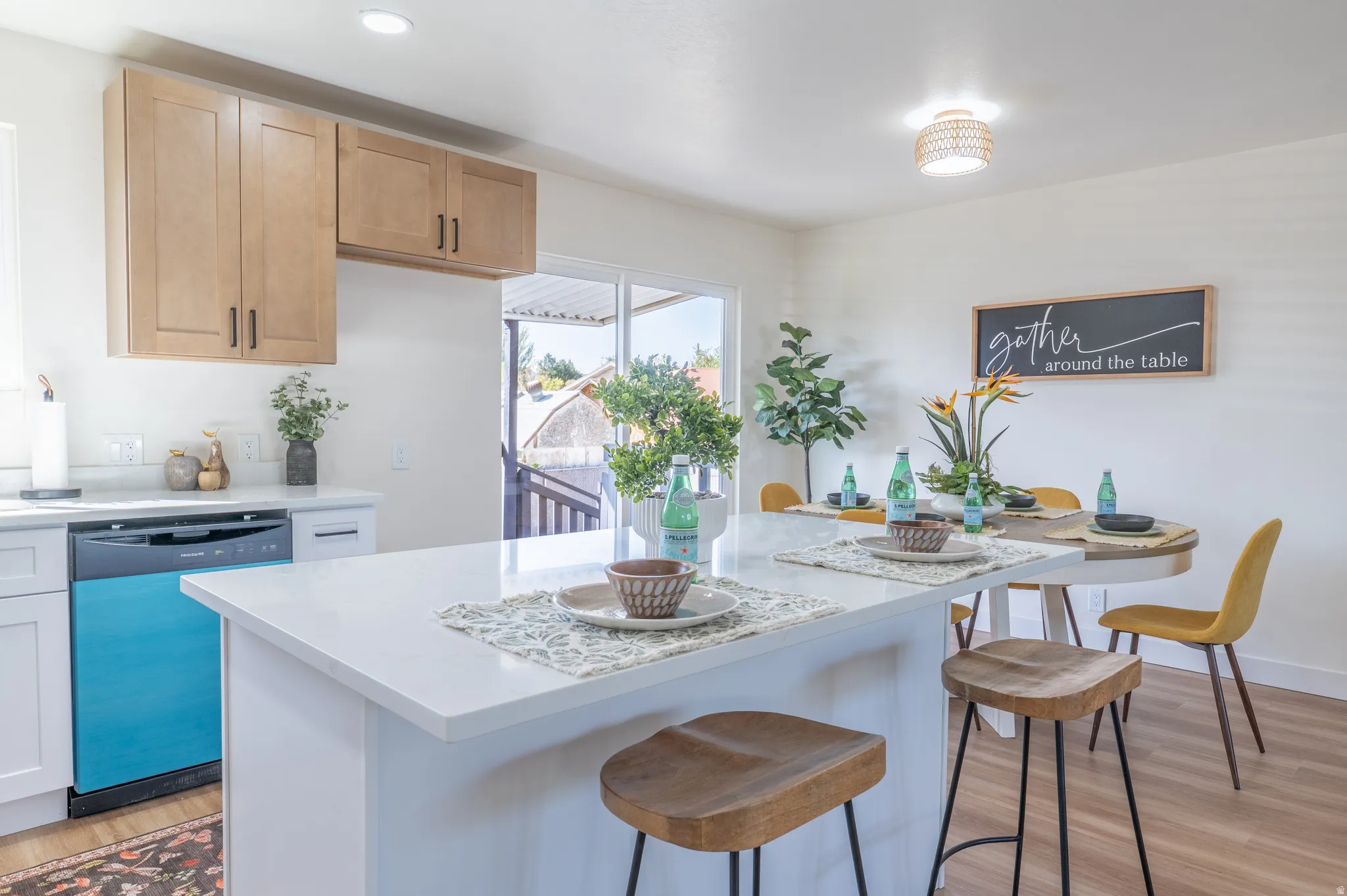 Kitchen featuring light wood-finish cabinetry, white countertops, built-in dishwasher, recessed lighting, and wood-finish flooring