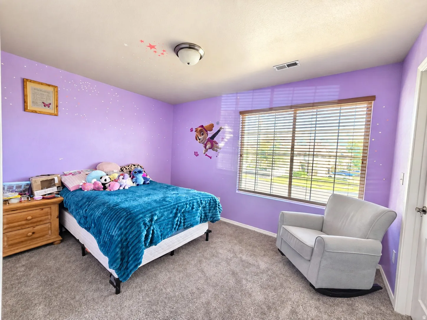 Recessed window with wood-finish blinds, gray carpet flooring, ceiling-mounted light fixture, and a solid door