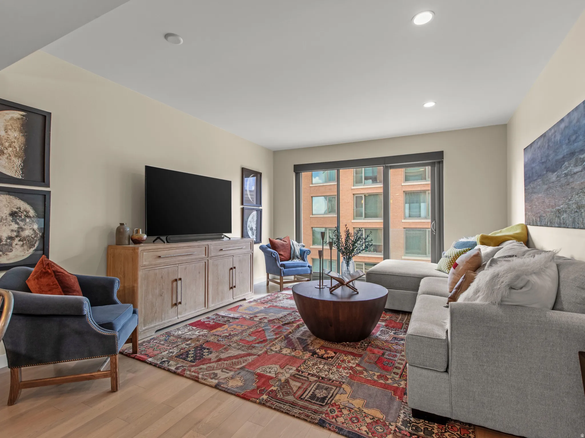 Recessed lighting, wood-finish flooring, large window, and light-toned walls