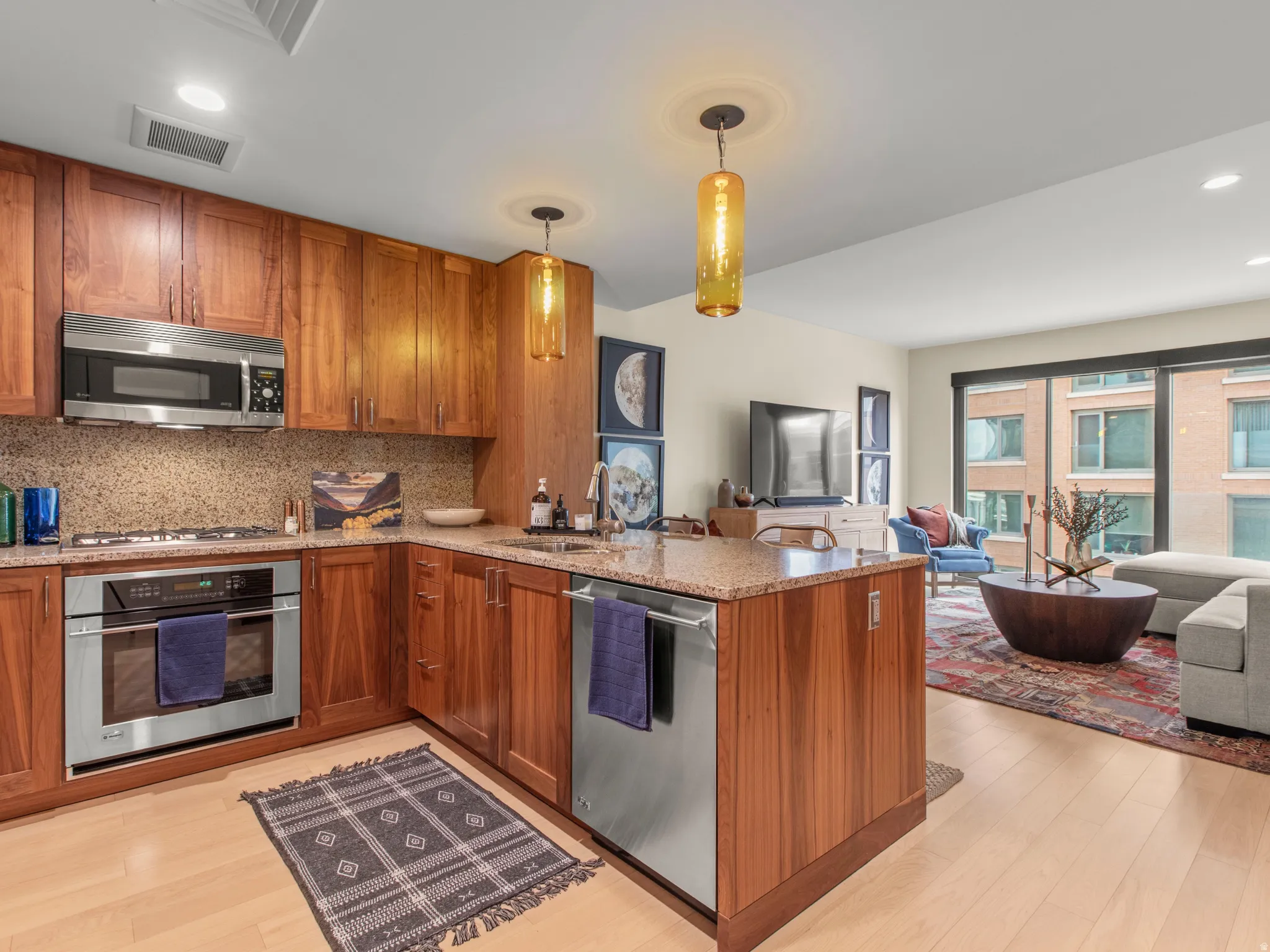 Kitchen featuring wood cabinetry, stainless steel appliances, and granite countertops