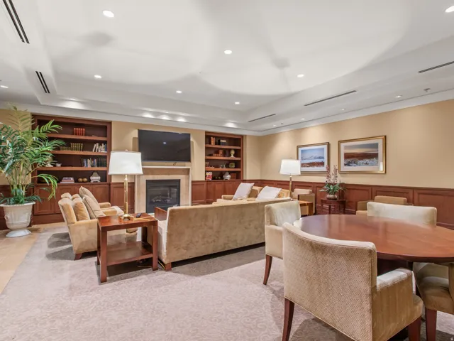 Built-in shelving, wainscoting, recessed lighting, fireplace, and carpet flooring