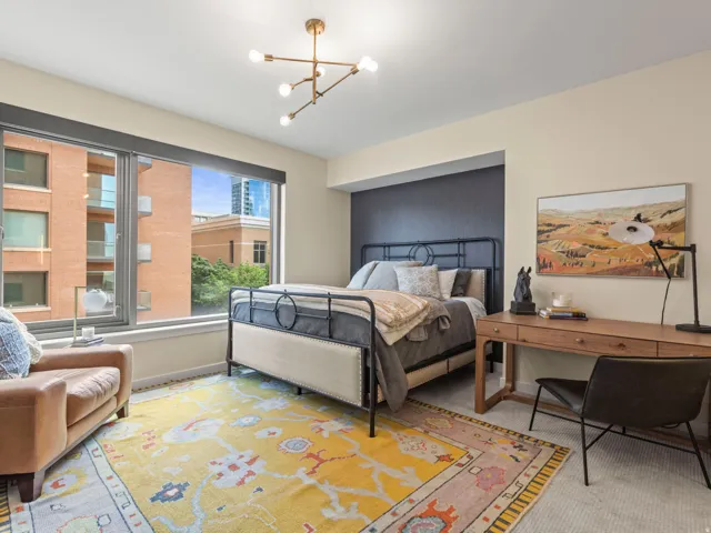 Spacious room with a large window, recessed wall feature, and a contemporary ceiling fixture