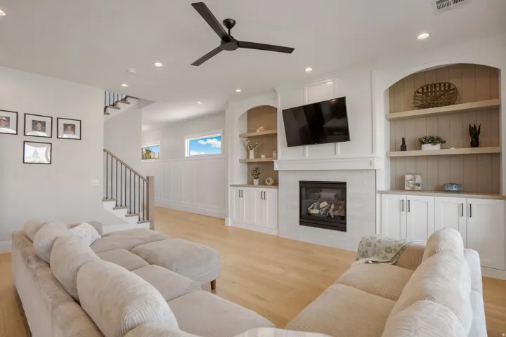 Built-in cabinetry flanking a fireplace with a light-toned tile surround