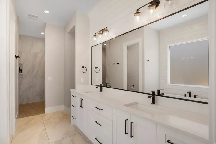 Dual vanity with white cabinetry and black hardware