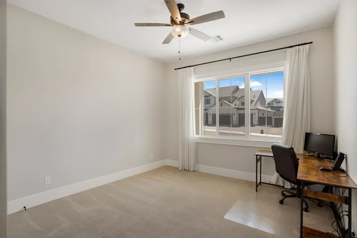Recessed lighting, ceiling fan, neutral wall paint, white trim, and a large window