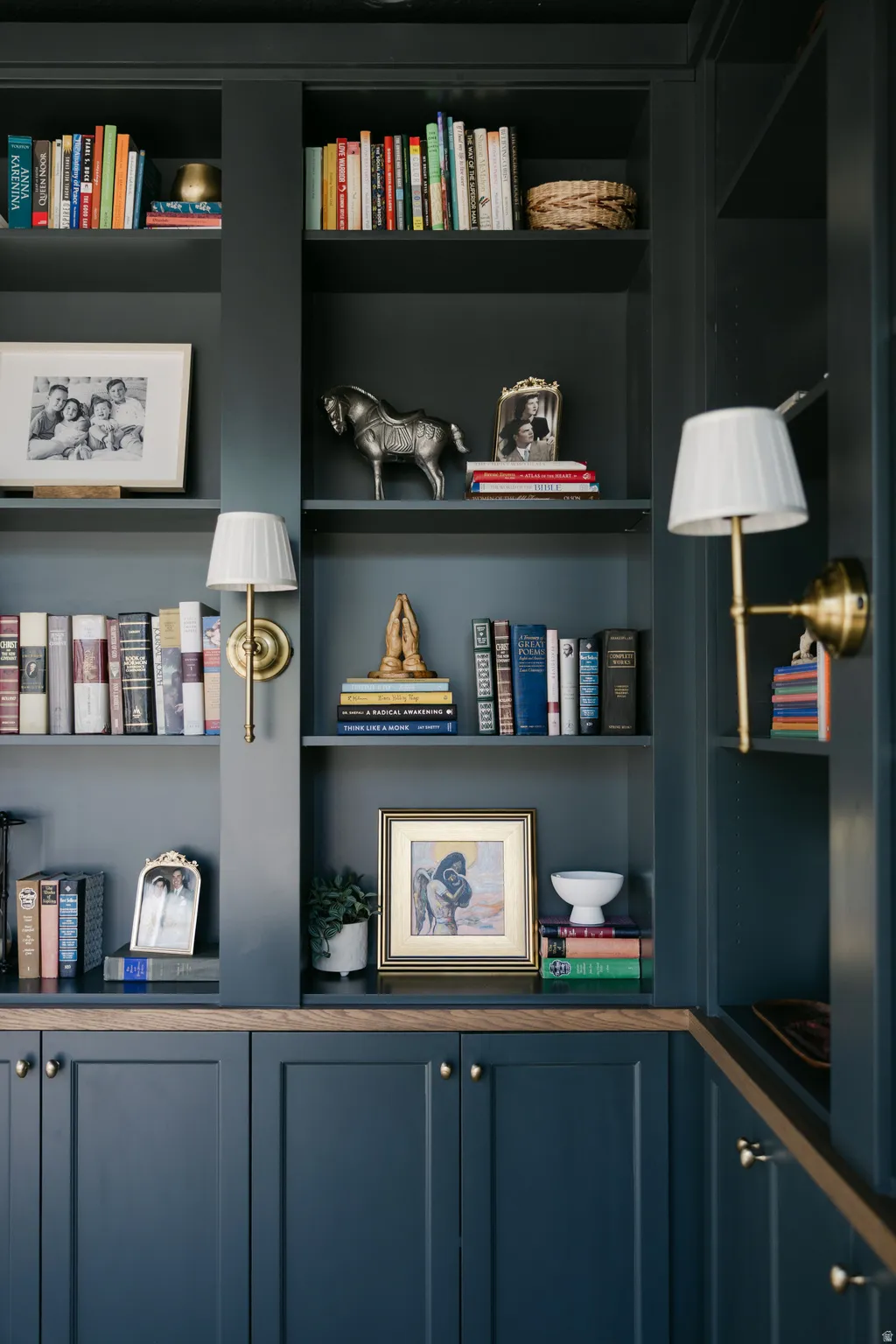 Built-in cabinetry with paneled doors, brass hardware, and wood-finish countertops