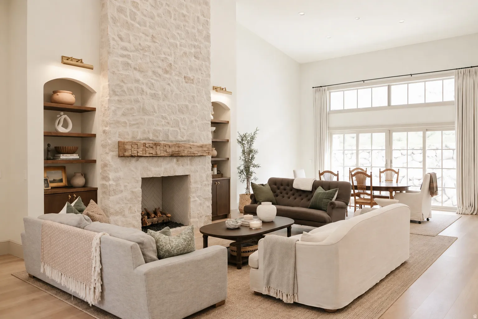 Stone-clad fireplace with a wood mantel, built-in arched shelving, and recessed lighting
