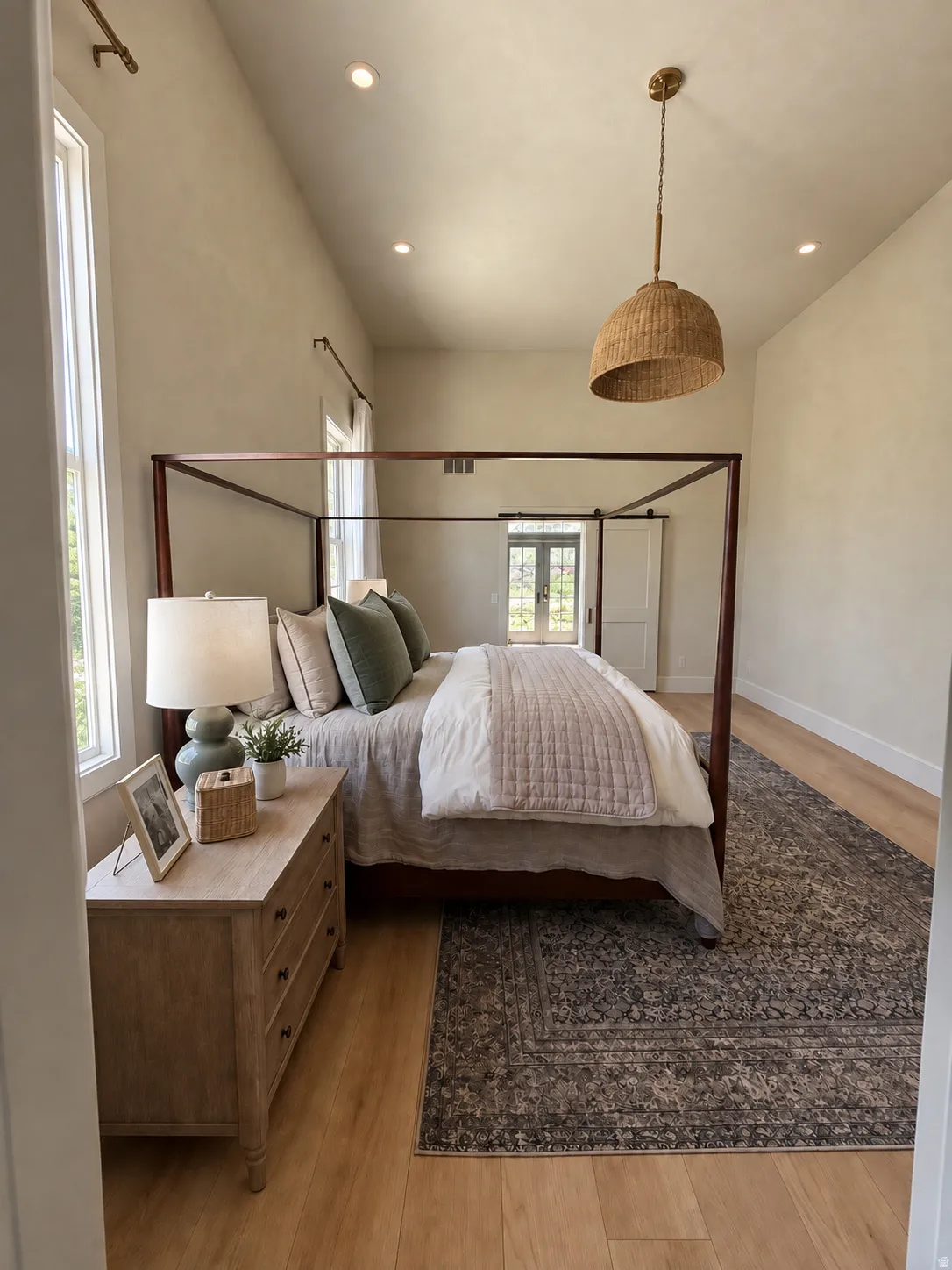 Vaulted ceiling with recessed lighting and a woven pendant fixture