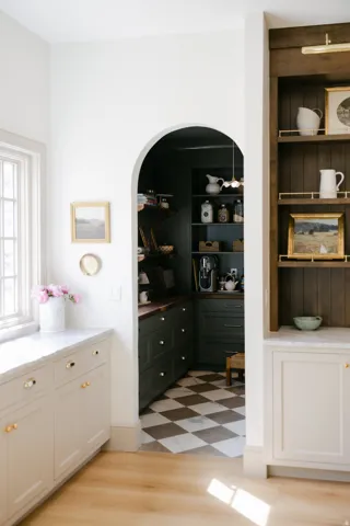 Arched doorway entry to pantry with checkerboard flooring