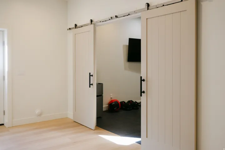Dual white barn doors with black hardware