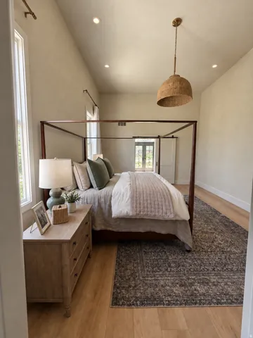 Vaulted ceiling with recessed lighting and a woven pendant fixture