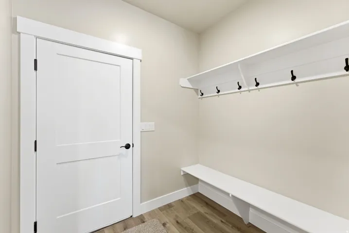 Built-in storage bench with overhead shelving and coat hooks