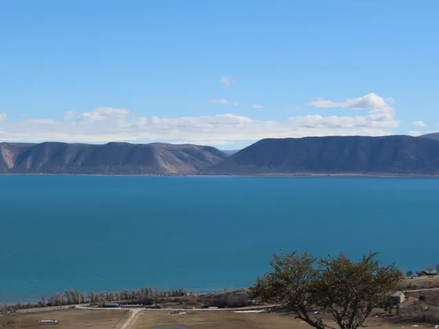 Expansive view of Bear Lake with distant mountainous terrain under a clear sky