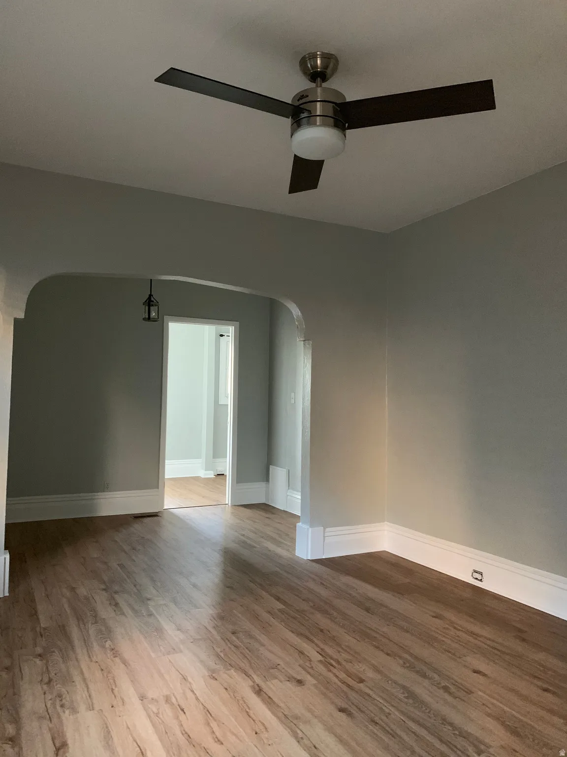 Wood-finish flooring throughout, complemented by light gray wall tones and white trim
