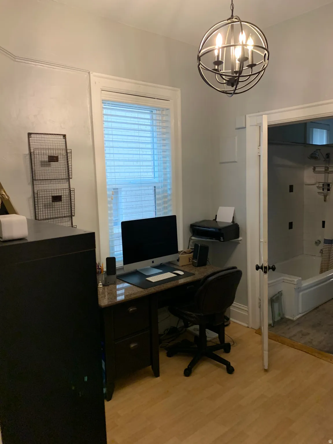 Recessed window with blinds, wood-finish flooring, and crown molding