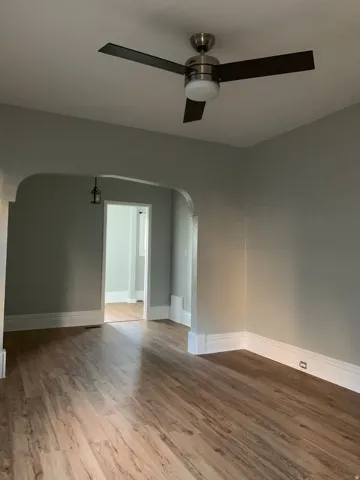 Wood-finish flooring throughout, complemented by light gray wall tones and white trim