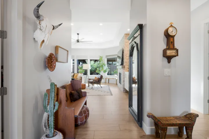 Wood-finish flooring, recessed lighting, and a partial view of a stone-clad fireplace