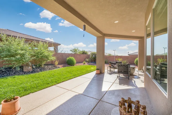 Covered patio with recessed lighting, concrete flooring, and an expansive lawn area