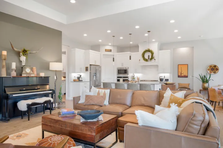 Recessed lighting illuminating the open-concept space, featuring wood-finish flooring