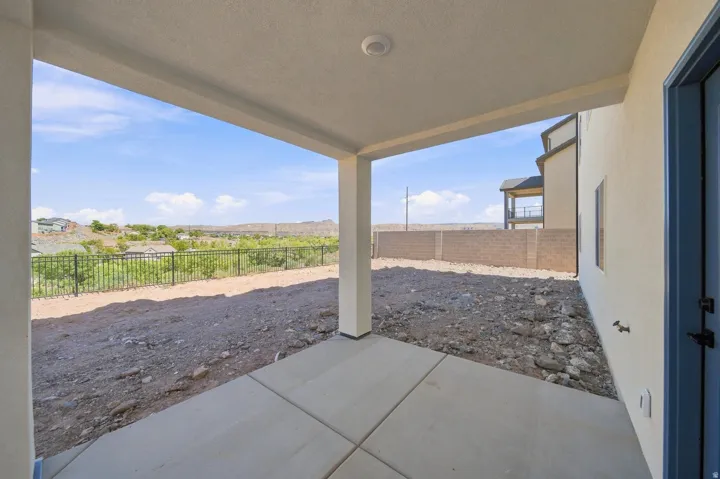 Covered patio with concrete flooring, recessed lighting, and a partially fenced yard