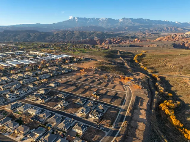 New residential development with established homes, developing lots, and surrounding natural landscapes