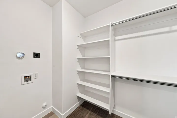Integrated laundry connections and built-in shelving with hanging rods