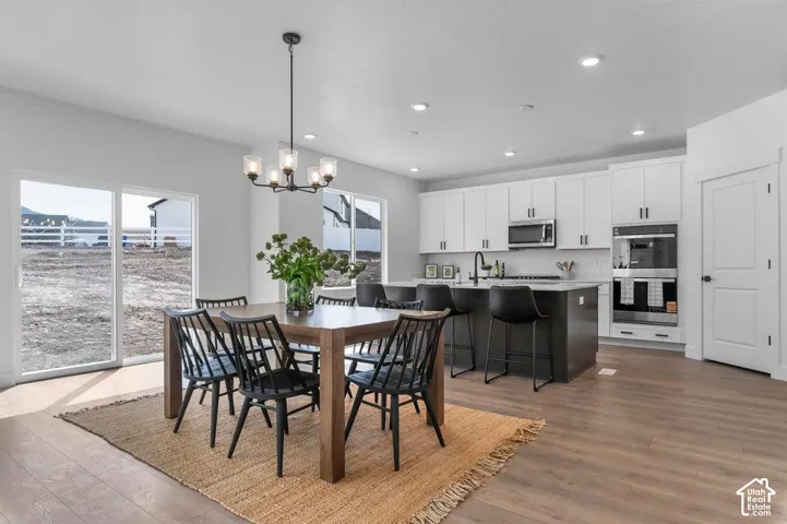 Open-concept kitchen with white upper cabinetry and a contrasting dark gray island