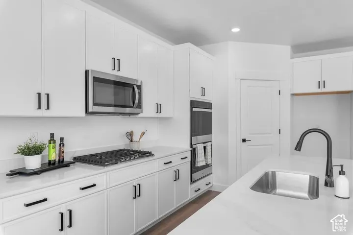 White cabinetry with modern black hardware