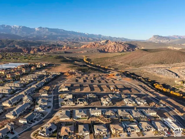 Expansive residential development with established homes, developing lots, and surrounding natural landscapes