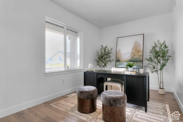 Wood-finish flooring and a single-pane window with white trim