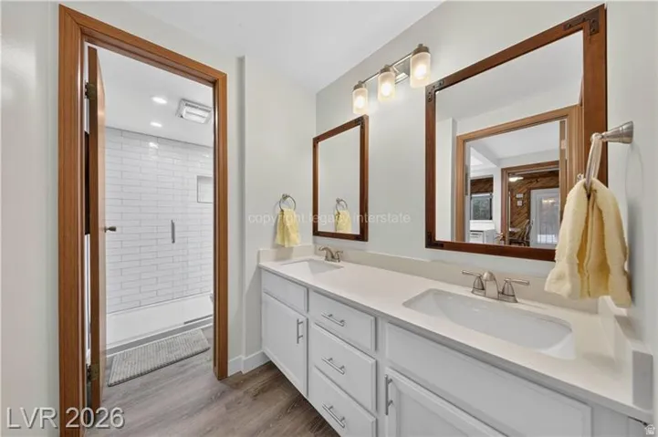 Dual vanity with integrated sinks and white cabinetry