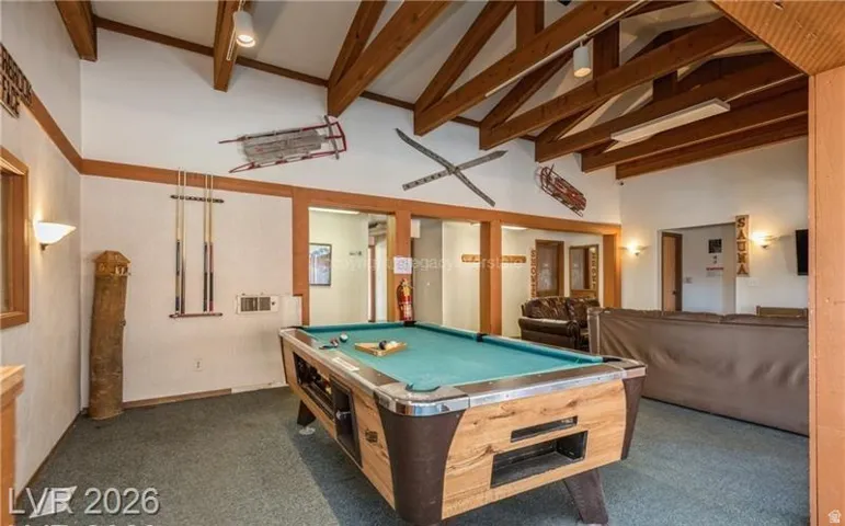 Game room featuring a billiard table, exposed wood beams, and a vaulted ceiling