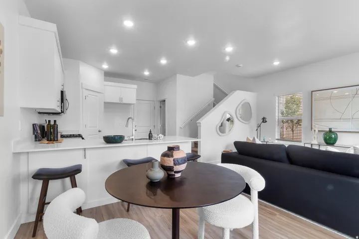 Kitchen featuring white cabinetry, light countertops, and a stainless steel sink