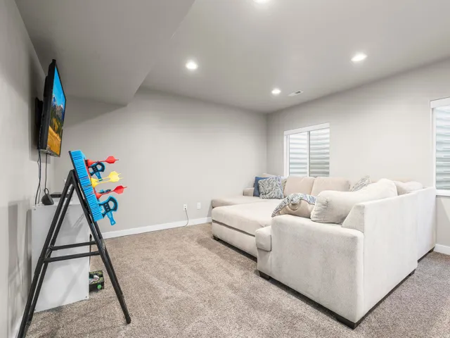 Bright recreational space featuring recessed ceiling lighting, neutral wall finishes, and plush carpeting