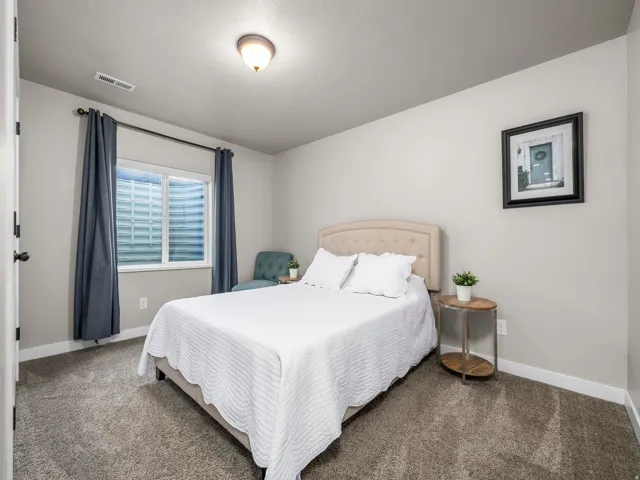 Soft gray wall paint with white trim, recessed window, and gray carpet