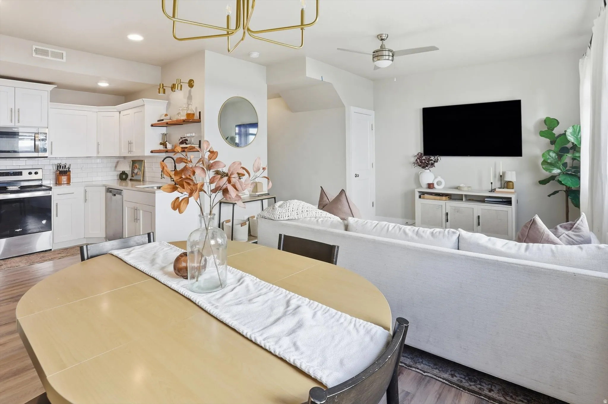 Open-concept living space with wood-finish flooring