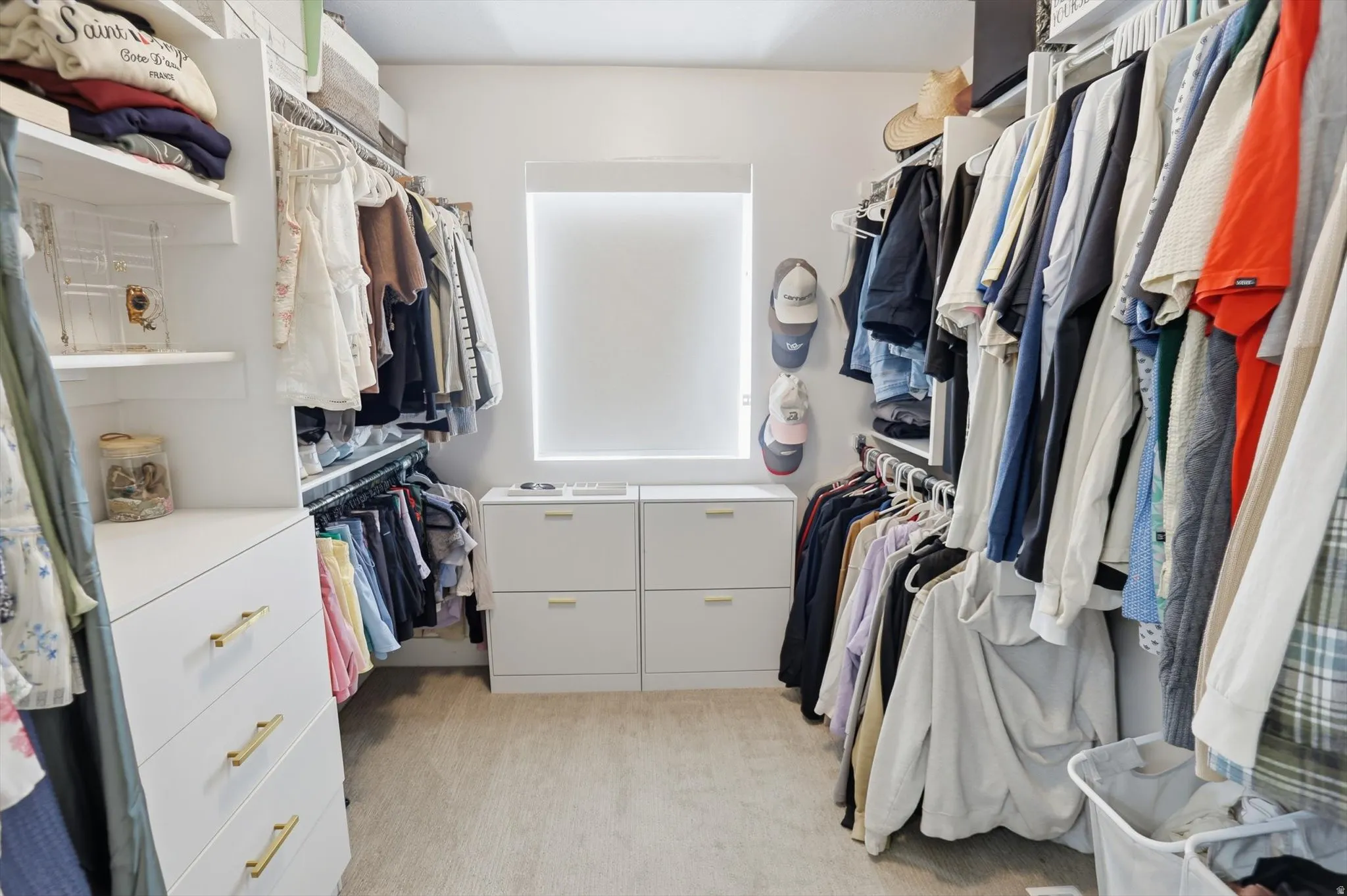 Custom closet system with built-in shelving, hanging rods, and integrated drawers