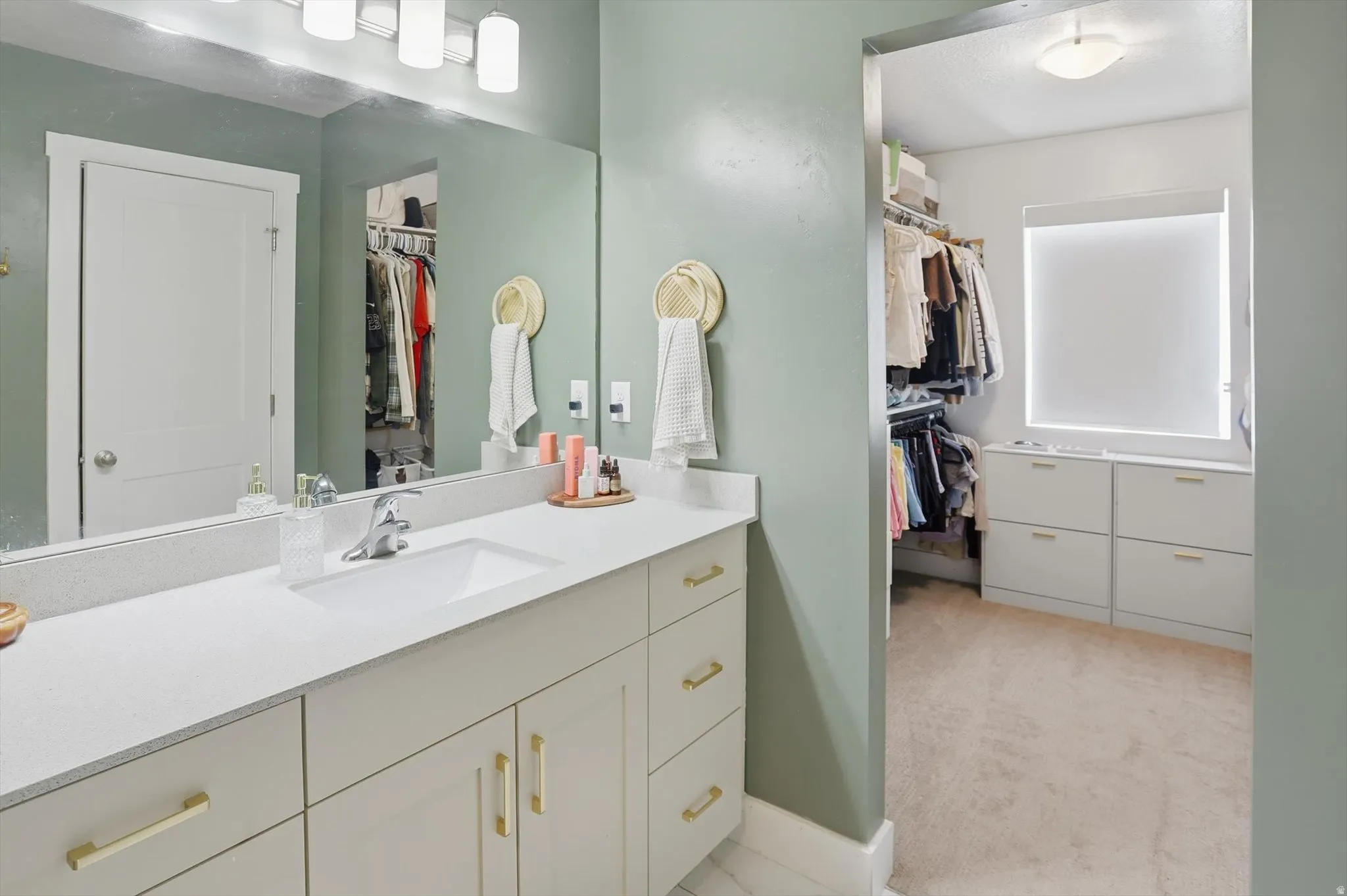Extended vanity with an integrated rectangular sink and polished chrome faucet