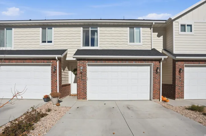 Two-story exterior with horizontal siding and brick accents