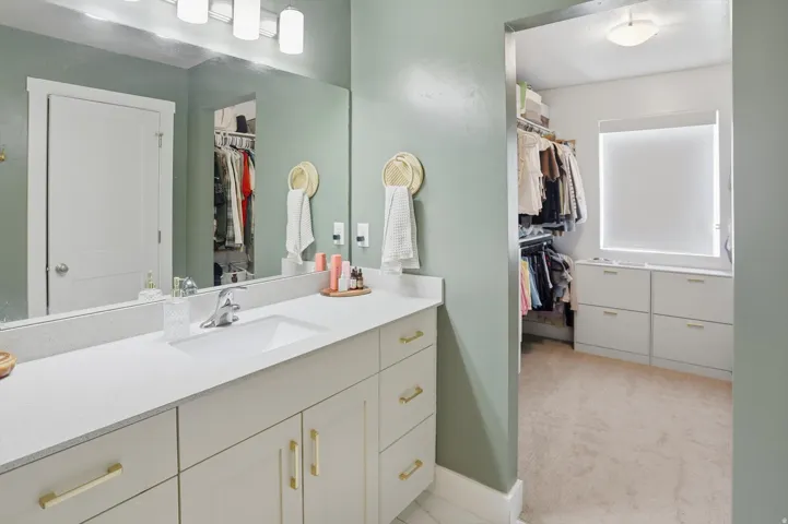 Extended vanity with an integrated rectangular sink and polished chrome faucet