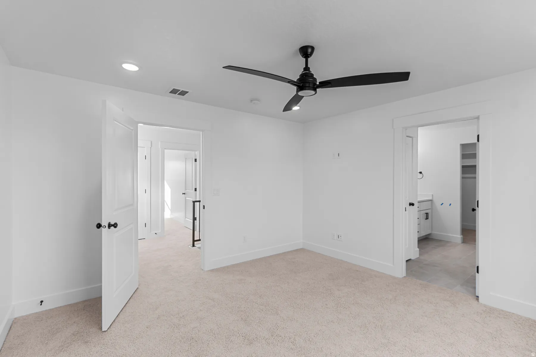 Plush carpet flooring, recessed lighting, and a contemporary ceiling fan