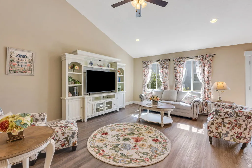 Vaulted ceiling with a ceiling fan, recessed lighting, and wood-finish flooring