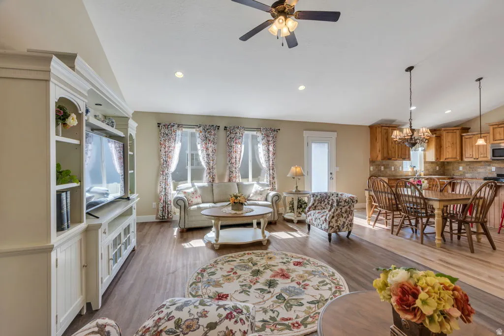 Open-concept interior featuring wood-finish flooring, recessed lighting, and a built-in media cabinet