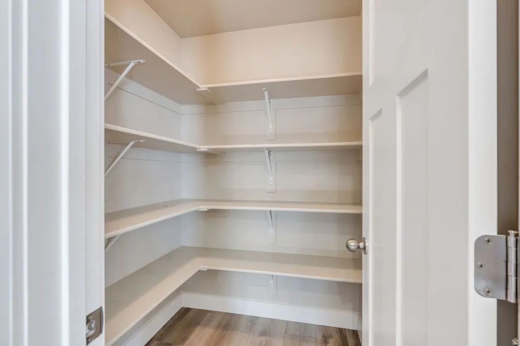 Built-in shelving, white painted interior, wood-finish flooring