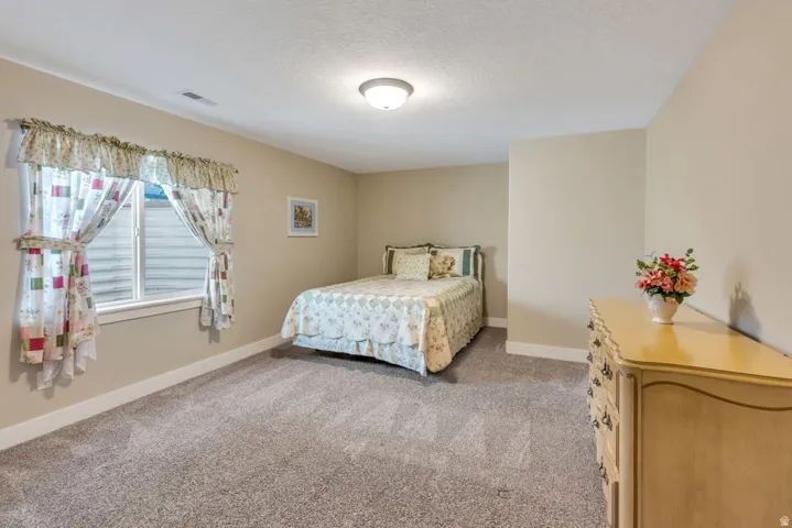 Recessed window with white trim, wall-to-wall carpeting, and neutral wall paint