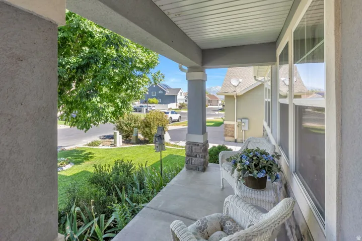 Covered front porch with concrete flooring and stucco exterior