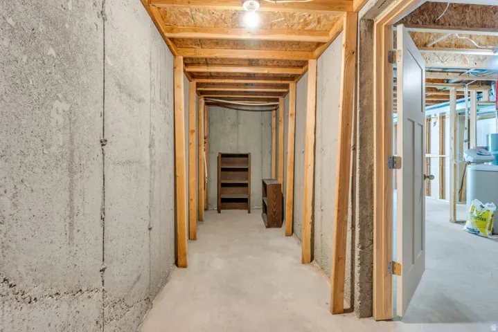 Cold Storage with concrete walls, exposed ceiling joists, and a partial hallway framing