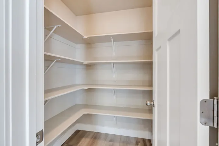 Built-in shelving, white painted interior, wood-finish flooring
