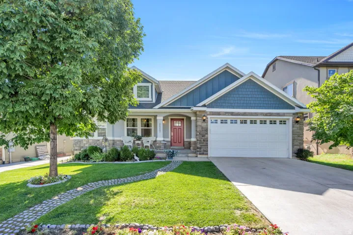 Stone and siding exterior with a prominent two-car garage
